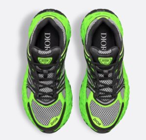 B35 NXXT limited edition shoe in neon green, black technical fabric, and gray mesh displayed on minimalist concrete backdrop